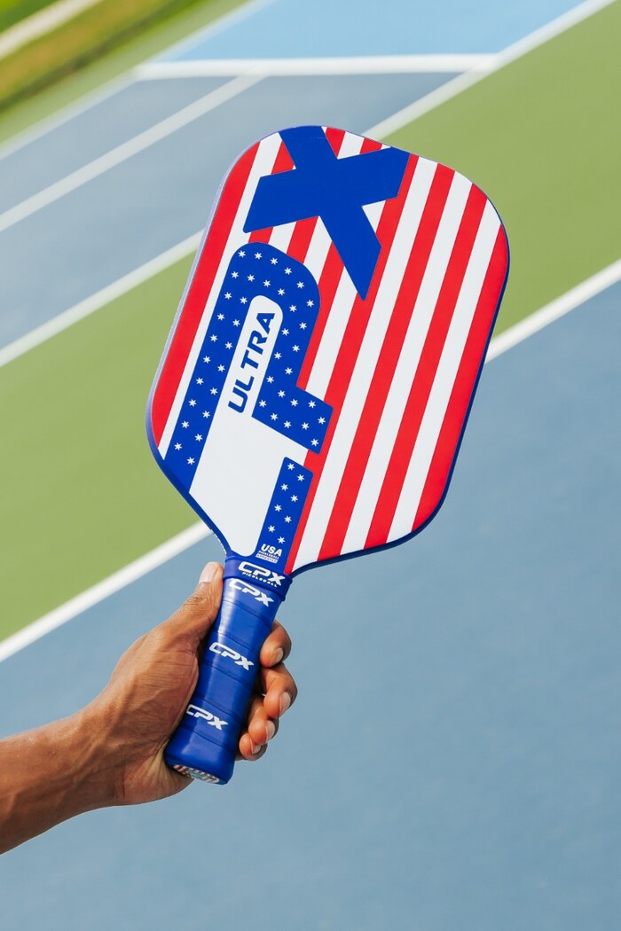 Player holding CPX Ultra Freedom paddle on the court