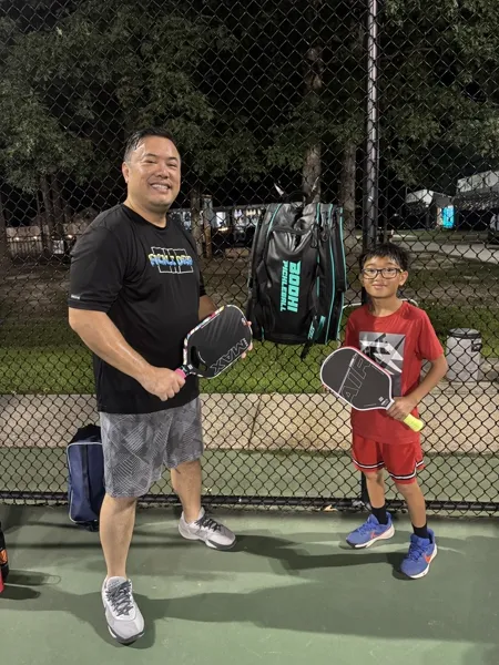 Player with Freedom paddle on blue court